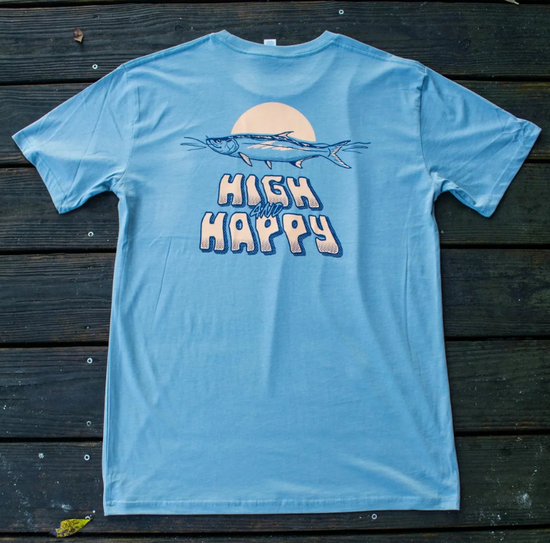 Light blue t-shirt with fish graphic and 'High and Happy' text on a wooden surface